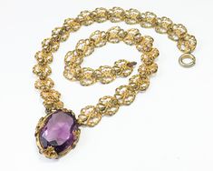 "~ 1930s ornate filigree amethyst pendant necklace ~ Beautiful flower prong set ~ Large faceted un-foiled purple glass ~ Intricate gold filigree necklace ~ Excellent Chain- 14\" (35.5 cm) Glass Stone- 1.25\" (3.25 cm) More Fantastic Vintage Jewelry: glennasvintageshop.etsy.com Additional Vintage in our sister shop Glenna's Jewels: glennasjewels.etsy.com Instagram @glennas_clothing Facebook https://www.facebook.com/glennasclothing" Formal Filigree Costume Jewelry Necklace, Formal Costume Jewelry Necklace With Filigree, Vintage Amethyst Jewelry With Intricate Design, Purple Vintage Jewelry With Intricate Design, Gold Amethyst Jewelry With Filigree, Vintage Purple Jewelry With Intricate Design, Gold Amethyst Jewelry With Filigree Detail, Ornate Amethyst Necklaces For Formal Occasions, Vintage Amethyst Pendant Necklace