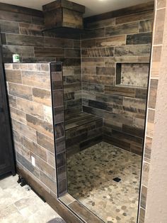 a walk in shower sitting inside of a bathroom