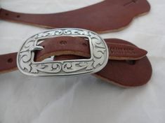 the belt is made from leather and has a metal buckle on it's side