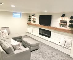 a living room filled with furniture and a flat screen tv mounted on the wall above a fireplace