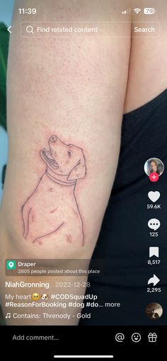 a tattoo on the back of a woman's arm with a dog drawn on it