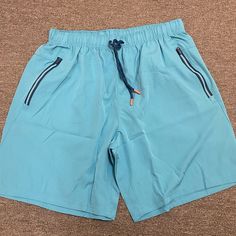 Blue Athletic Shorts Size Large. Brand New And Never Worn. Casual Blue Swim Trunks With Built-in Shorts, Blue Shorts With Elastic Waistband For Poolside, Blue Poolside Shorts With Elastic Waistband, Blue Short Swim Trunks With Elastic Waistband, Casual Blue Swim Trunks With Elastic Waistband, Blue Sporty Shorts With Pockets, Blue Swim Trunks With Elastic Waistband, Blue Swim Trunks With Pockets For Poolside, Blue Shorts For Poolside