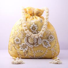 Material:Silk, Golden Tread, Golden Sequins, Motifs Color: Pink, Orange, Yellow, Blue Package Contents: As per quantity purchased Designed with the heart, this beautiful Potli or batawa bag are eye catchy and made of premium material. Key Features: Embroidery art work. This potli is good match with both Indian and western outfits and are superb for wedding and festive parties. This would be best complement to your designer saree, lenhga or any other kind of dress. This is the combination of trad Elegant Embroidered Fabric With Dori Work For Celebration, Traditional Gold Embroidered Bags For Celebration, Traditional Bags With Gold Embroidery For Celebration, Festival Embroidered Evening Bag For Celebrations, Elegant Beaded Festive Bags, Elegant Potli Bag With Dori Work For Celebrations, Elegant Embroidered Fabric With Dori Work For Festivals, Traditional Embellished Shoulder Bag For Celebrations, Elegant Gold Embroidered Potli Bag For Festive Occasion