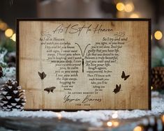 a wooden plaque with a poem written in the shape of a butterfly and pine cones