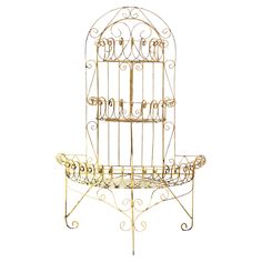 a metal birdcage sitting on top of a table