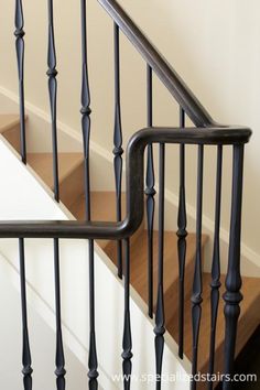 an image of a set of stairs with wood handrails