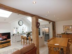 a living room filled with furniture and a flat screen tv on top of a wooden table