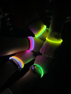 glow bracelets are glowing in the dark with neon colors on their wristbands