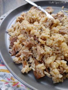 a plate with rice and meat on it