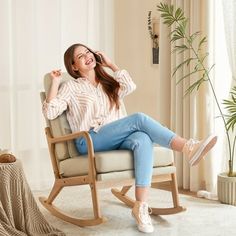 a woman sitting in a rocking chair talking on the phone