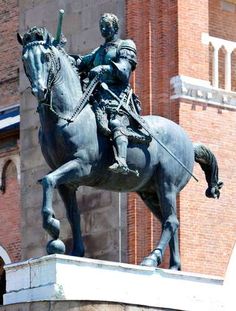 a statue of a man riding on the back of a horse