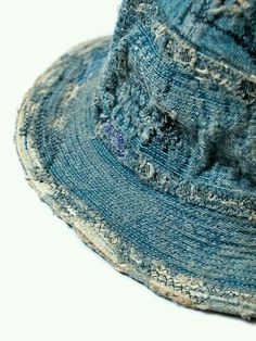 a blue jean hat with holes on it