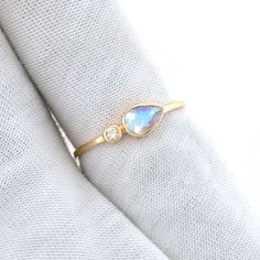 Natural Rainbow Moonstone Ring, SI Clarity, G-H Color Diamond Attractive Wedding Gift Ring, Handmade Minimalist Jewelry 14k Solid Gold Ring * Item Coad : NTFPN015 ≫ Features * Metals : 14k/18k Solid Gold  * Gemstone : 100% Genuine Rainbow Moonstone  * Moonstone Weight - 0.36 ct (3x5 mm) * Band Width : 1.3 mm width * Diamond Wt : 0.03 ct * Diamond : 100% Genuine Diamond * Diamond Cut: Brilliant Cut (Excellent) * Real Earth Mines Diamond * Gemstone Color: G-H * Gemstone Clarity: SI-1, SI-2 * 14K S Modern Gold Moonstone Rings, Minimalist Moon-shaped Moonstone Ring For Gift, Raw Rainbow Moonstone Ring, Rainbow Moonstone Jewelry, Solid Gold Ring, Rainbow Moonstone Ring, Etsy Gold Ring, Natural Rainbow, Gift Ring