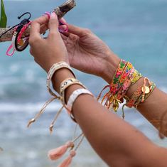 A model wearing the the Jungle Bali Friendship Bracelet Bundle from Love Is Project Tropical Bracelets, Green School Bali, Alice Core, Tag Sticker, Cloth Pouch, Woven Bracelets, Good Friends, Women Artisans, Jewelry Inspo