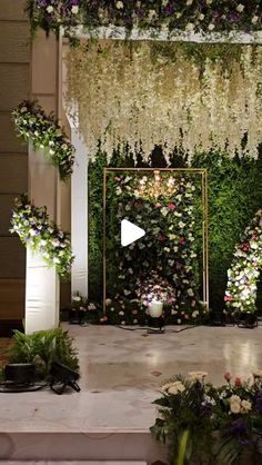 an outdoor ceremony setup with flowers and greenery