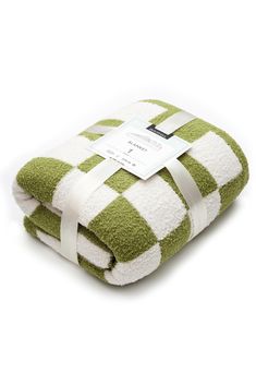 green and white checkered towel folded on top of each other with a tag attached to it