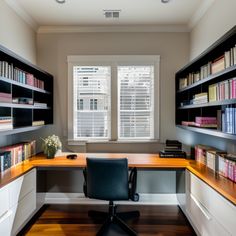 a home office with bookshelves, desk and chair in front of the window