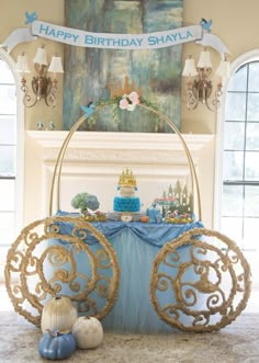 a birthday cake is displayed in front of a fireplace with an ornate cart on the mantle