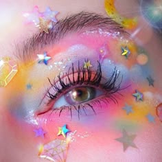 a woman with colorful makeup and stars on her face