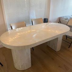 a large white table with chairs around it