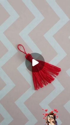 a red tasseled keychain hanging from the ceiling with hearts on it