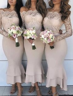 three bridesmaids in long dresses standing next to each other and holding bouquets