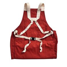 a red apron with white straps on the front and back, attached to an adjustable belt