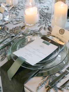 Are you searching for timeless wedding table decor ideas for you dream wedding? The wedding table decor had white pillar candles in glasses as wedding table centerpieces. The elegant place setting had clear plates, a classic wedding menu placed on the plates with silver utensils and a dark green velvet napkin. The wedding table cloth has silver sequined greenery that paired well with the green and white wedding colors. The wedding tablescape had a classic wedding aesthetic. Follow @classicplanninganddesignco for more timeless and traditional wedding table decor ideas! Photo: Katherine & Tyler Photography Traditional Wedding Table Decor, Classic Wedding Aesthetic, Wedding Table Decor Ideas, Wedding Table Cloth, Wedding Table Place Settings, Silver Utensils, Elegant Place, Clear Plates, White Pillar Candles