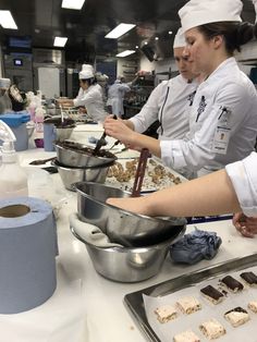 two chefs are preparing food in a kitchen