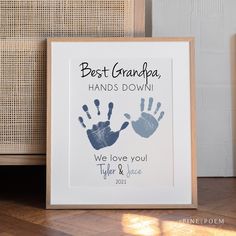 a framed print with the words best grandpa hands down and two handprints on it