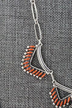 This intricately crafted coral and sterling silver necklace and earrings set was made by Zuni silversmith Stewart Nakatewa. The back of the necklace is signed.Necklace: 15"Length: 1 1/4"Width: 2 3/8"Earrings:Length: 1 1/2"Width: 3/8"Free shipping on all orders! We ship with USPS and always include tracking. All orders ship within a day of payment.Returns are accepted up to 30 days after you receive your order. Just send us a message. Our shop offers cash back or store credit. The item must be re Red Sterling Silver Jewelry With Inlay, Elegant Coral Sterling Silver Jewelry, Handmade Coral Sterling Silver Jewelry, Red Southwestern Sterling Silver Necklace, Handmade Silver Jewelry With Red Coral, Red Sterling Silver Necklace With Oxidized Finish, Native American Jewelry, Free Jewelry, Sterling Silver Necklaces