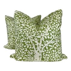 two green and white pillows with trees on them