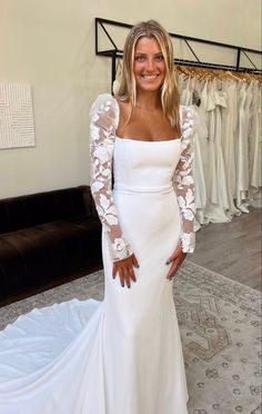 a woman in a white wedding dress posing for the camera