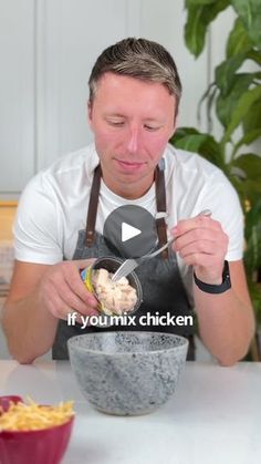 a man in an apron mixing food into a bowl