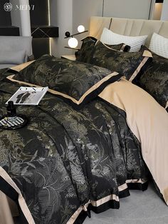 a bed with black and tan comforters in a bedroom setting, next to a night stand