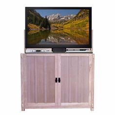 an entertainment center with a flat screen tv on it's side and mountains in the background