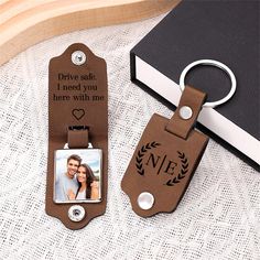 a couple's photo is attached to a leather keychain with a personal message