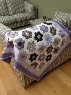 a couch with a quilt on top of it