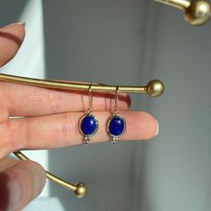 14KT yellow gold oval, blue lapis gemstone earring charms with detailed frame on shepard hook. Charming oval, blue lapis charms with yellow gold bail + detailing. Length: 29mm Width: 10mm Flat backside Weight: 1.36 grams Stamped 14K Genuine lapis stones Shepards Hook, Earring Charms, Blue Lapis, Hook Earrings, Charm Earrings, Gemstone Earrings, Charms, Yellow Gold, Gemstones