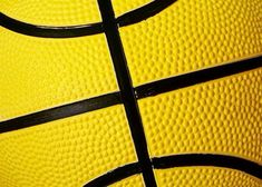 a close up view of a yellow basketball ball with black lines on it's surface