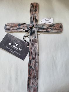 a wooden cross with a tag attached to it