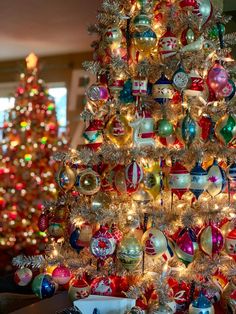 a brightly colored christmas tree with ornaments on it