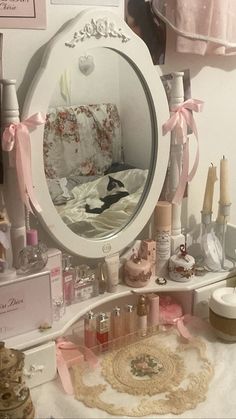 there is a vanity mirror with pink bows on it