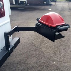 the back end of a trailer with a red grill attached to it's side