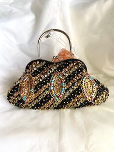 gorgeous black beaded patterned bag! embroidered vintage tote bag! It is the fashion of the past carried to the present. glamorous vintage handbag is satin finish. It has a wonderful pattern embroidered with beads on it. These embroideries are handcrafted. this vintage bag is black in color. Kiss lock is used. The frame is silver in color. It is a special bag that you can use everywhere as an evening bag, daily bag, wedding bag, party bag, evening bag. It has a mini pocket inside. It has a silve Luxury Hand-embellished Black Evening Bag, Luxury Hand Embellished Black Evening Bag, Hand Embellished Black Evening Bag, Luxury Black Hand Embellished Evening Bag, Multicolor Sequined Evening Bag, Black Embellished Top Handle Bag, Black Hand Embellished Evening Bag, Elegant Black Hand-embellished Bag, Elegant Hand Embellished Black Bag