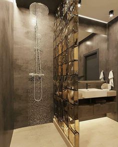 a bathroom with a glass shower head next to a sink