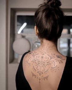 a woman with a tattoo on her back