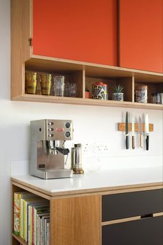 a coffee machine sitting on top of a counter next to a shelf filled with books