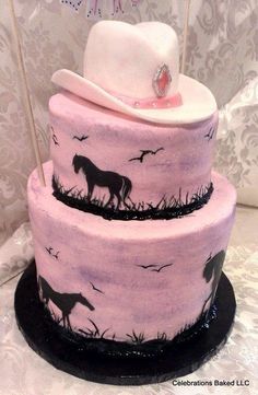 a three tiered cake decorated with pink frosting and black icing, topped with a cowboy's hat