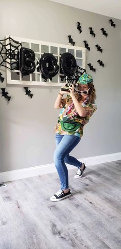 a woman standing in front of a wall with bats on it and holding a cell phone to her ear